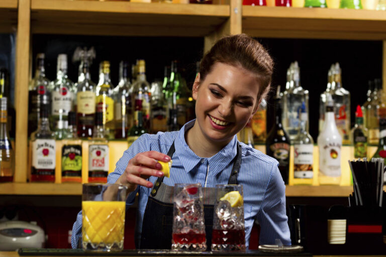 The bartender prepares cocktails at the bar