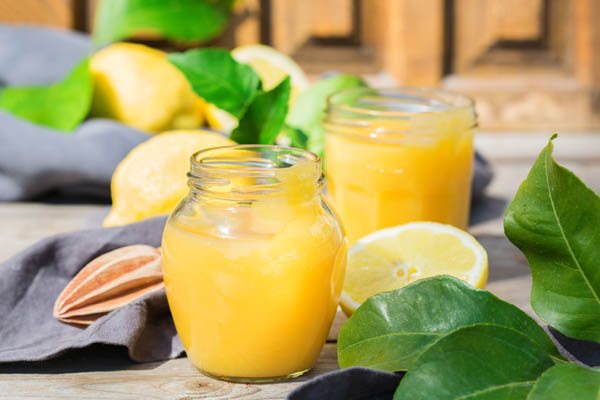 Lemon Curd in einem Glas mit Zitronenscheiben